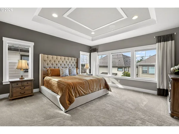 a spacious bedroom with a large bed and a large window