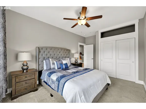 a bedroom with a large bed and a chandelier