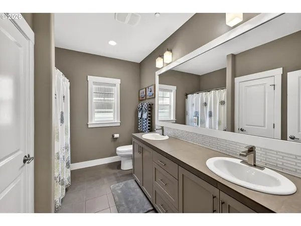 a bathroom with a sink double vanity granite and a mirror