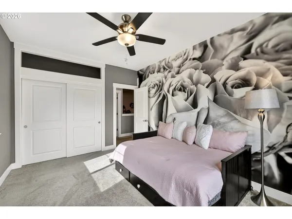 a bedroom with a large bed and a chandelier