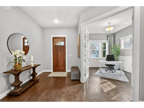 a living room with furniture and a large mirror