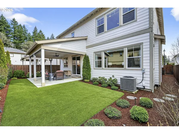 a view of a house with backyard porch and sitting area