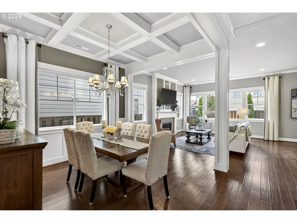 a dining room with furniture window and wooden floor