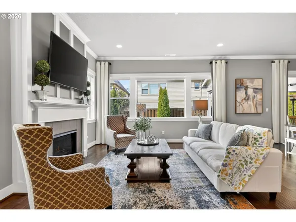 a living room with furniture a flat screen tv and a fireplace