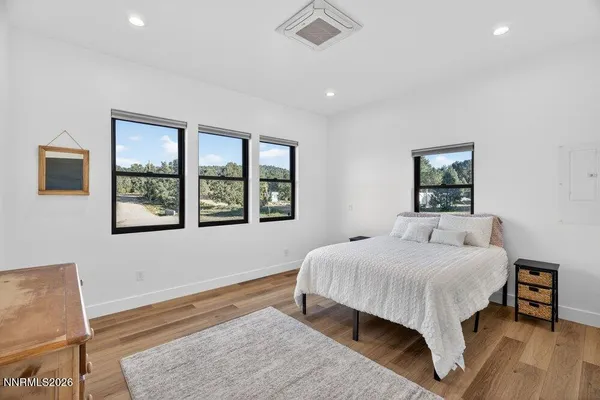 a bedroom with a large bed and a window
