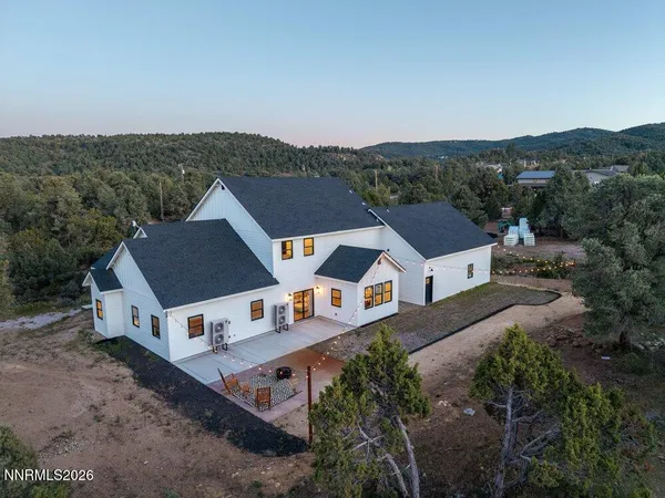 an aerial view of a house with a big yard