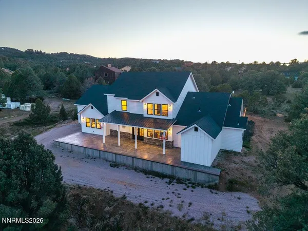 an aerial view of a house with a big yard