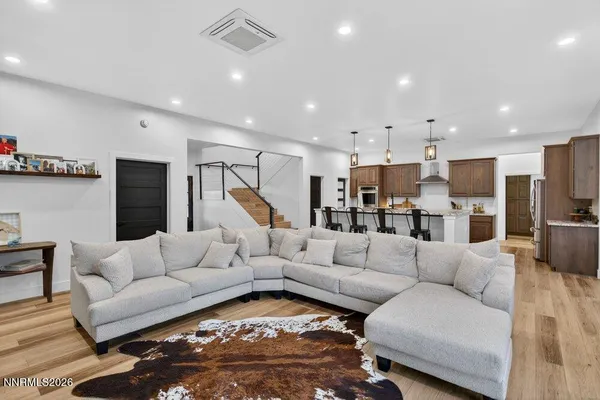 a living room with furniture and kitchen view