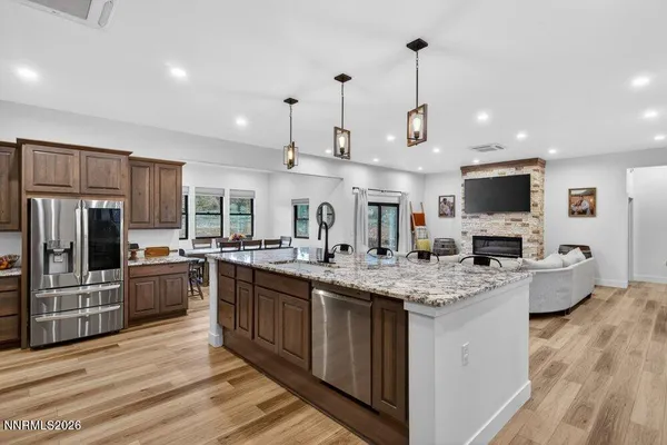 a kitchen with stainless steel appliances granite countertop a sink stove and refrigerator