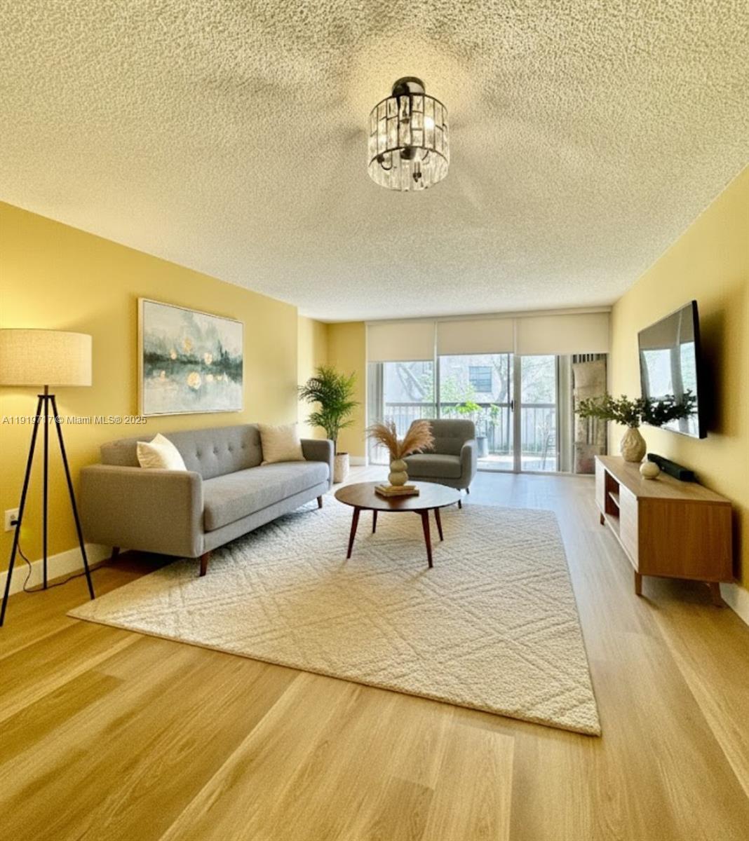 10985 Southwest 107th Street, Unit 216 Miami, FL 33176 - Photo 1 of 39 a living room with furniture and a flat screen tv