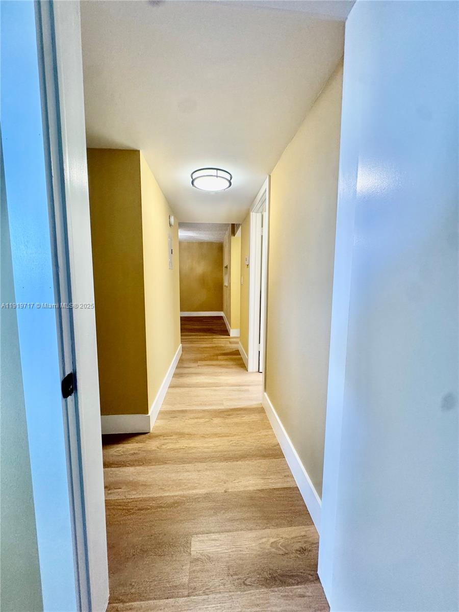 10985 Southwest 107th Street, Unit 216 Miami, FL 33176 - Photo 16 of 39 a view of a hallway with wooden floor