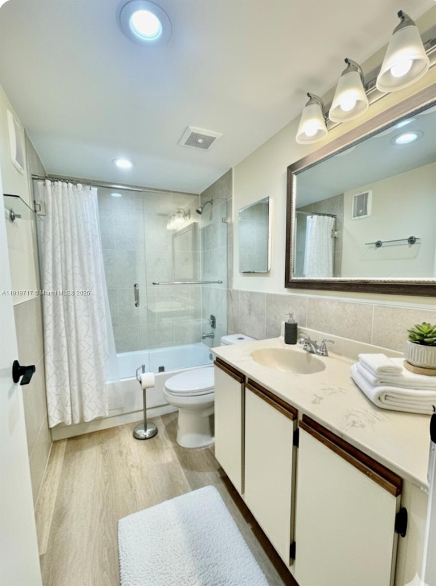10985 Southwest 107th Street, Unit 216 Miami, FL 33176 - Photo 19 of 39 a bathroom with a granite countertop sink mirror and a toilet