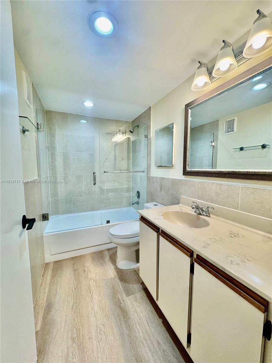 10985 Southwest 107th Street, Unit 216 Miami, FL 33176 - Photo 20 of 39 a bathroom with a tub sink and mirror