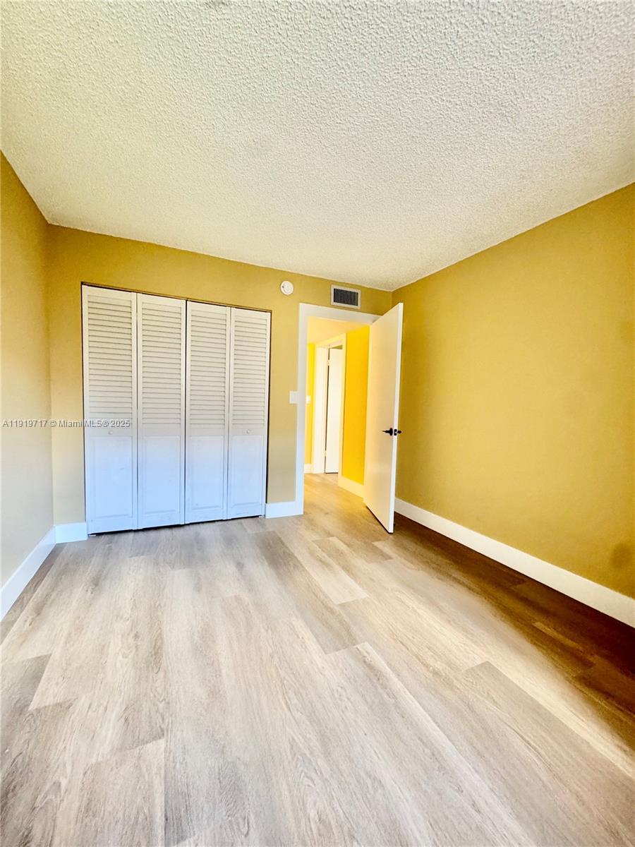 10985 Southwest 107th Street, Unit 216 Miami, FL 33176 - Photo 22 of 39 an empty room with a natural light