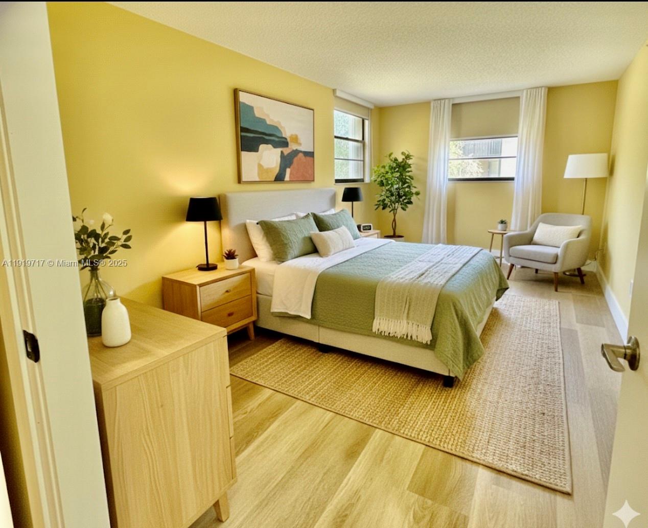 10985 Southwest 107th Street, Unit 216 Miami, FL 33176 - Photo 23 of 39 a bedroom with a bed and wooden floor