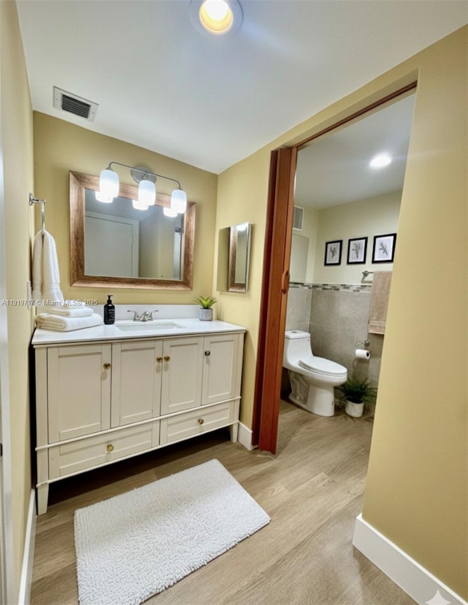 10985 Southwest 107th Street, Unit 216 Miami, FL 33176 - Photo 27 of 39 a bathroom with a sink a toilet and mirror