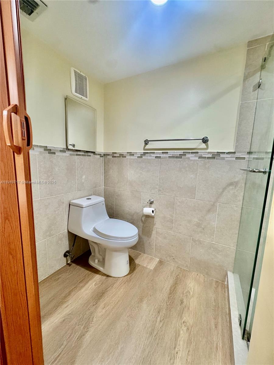 10985 Southwest 107th Street, Unit 216 Miami, FL 33176 - Photo 28 of 39 a white toilet sitting next to a shower