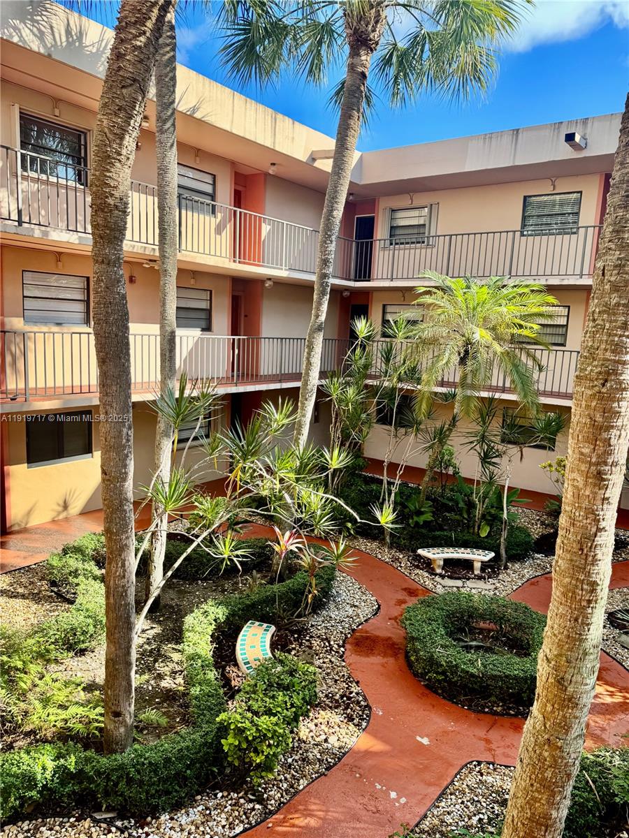 10985 Southwest 107th Street, Unit 216 Miami, FL 33176 - Photo 31 of 39 a backyard of a house with lots of green space and outdoor seating