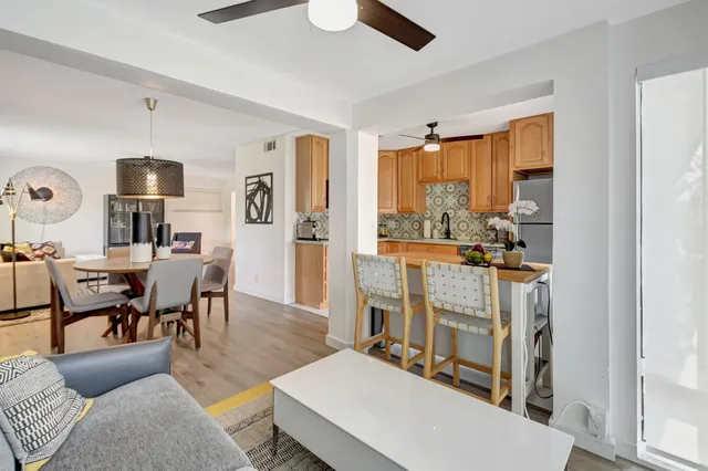 a living room with furniture a flat screen tv and a large window