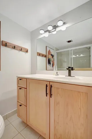 a spacious bedroom with a bed and ceiling fan