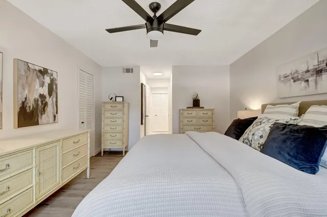 a bedroom with a bed a window and dresser