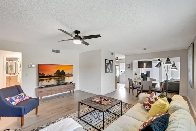 a living room with furniture a rug and a flat screen tv