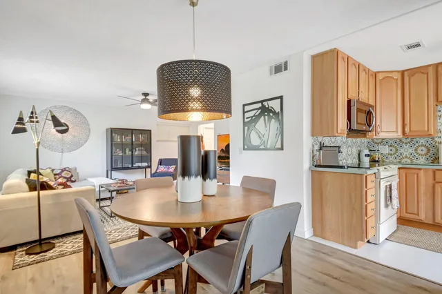 a dining room with furniture and wooden floor