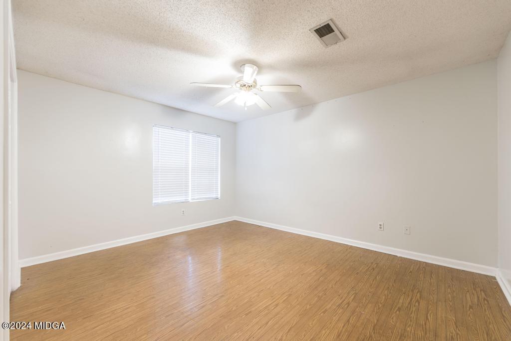 114 Wesleyan Way Macon, GA 31210 - Photo 14 of 28 an empty room with a window and a ceiling fan