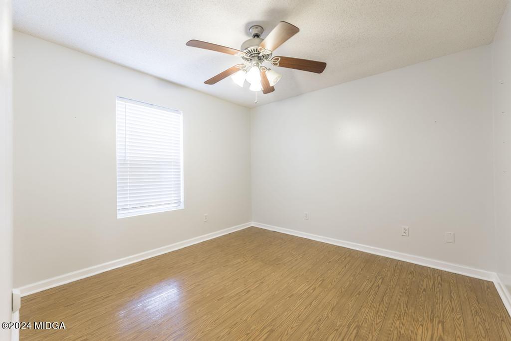 114 Wesleyan Way Macon, GA 31210 - Photo 21 of 28 an empty room with a window and a ceiling fan
