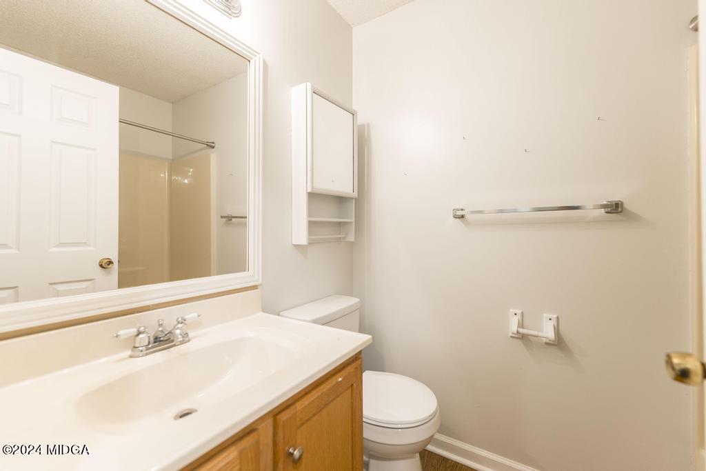 114 Wesleyan Way Macon, GA 31210 - Photo 23 of 28 a bathroom with a sink a toilet and a mirror