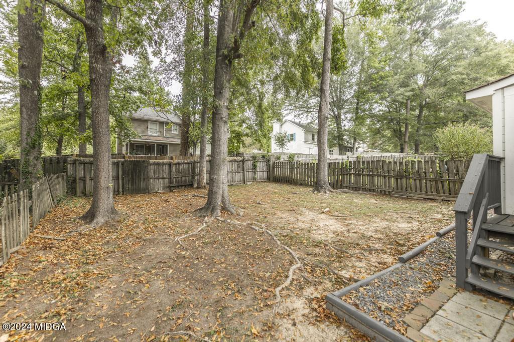 114 Wesleyan Way Macon, GA 31210 - Photo 26 of 28 a view of a backyard with wooden fence and large trees