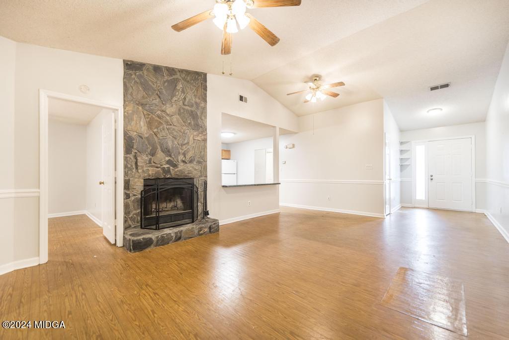 114 Wesleyan Way Macon, GA 31210 - Photo 8 of 28 a view of a livingroom with a fireplace a chandelier and wooden floor