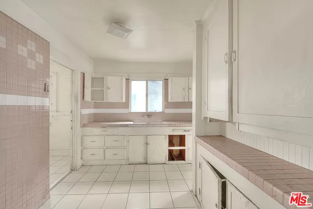 a bathroom with a granite countertop sink a toilet and a bathtub