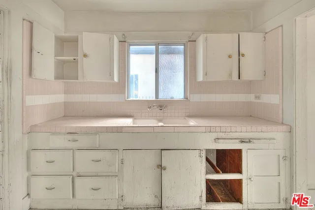 a bathroom with a sink and cabinets