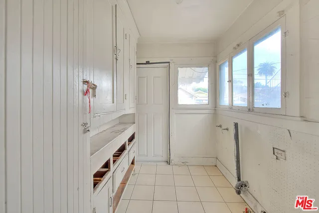 a bathroom with a double vanity sink a mirror and a shower