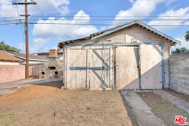 a view of backyard with barbeque grill and a fireplace