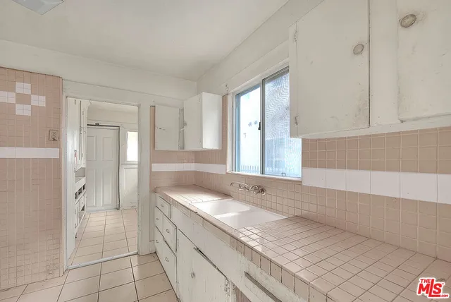 a spacious bathroom with a sink a mirror and a shower