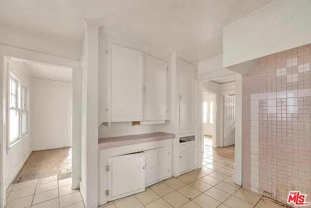 a view of a storage & utility room with cabinets