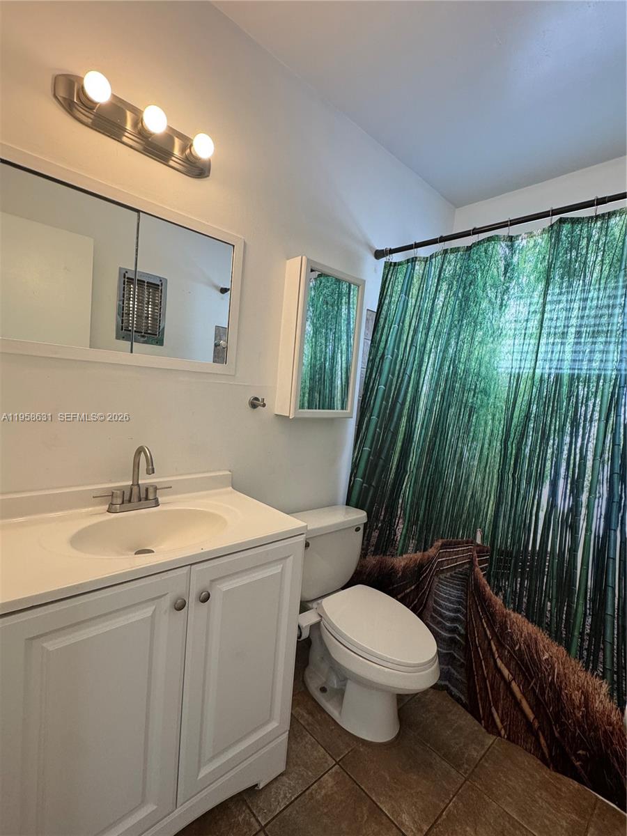 921 Meridian Avenue, Unit 7 Miami Beach, FL 33139 - Photo 11 of 33 a white toilet sitting next to a bathroom sink