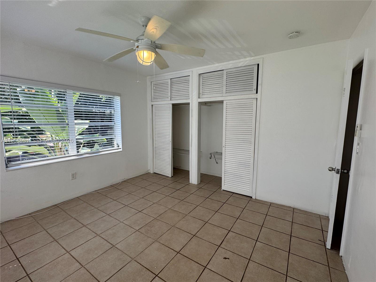 921 Meridian Avenue, Unit 7 Miami Beach, FL 33139 - Photo 12 of 33 a view of an empty room with window and cabinet area