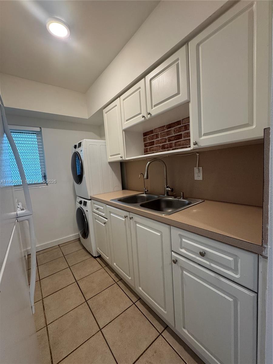 921 Meridian Avenue, Unit 7 Miami Beach, FL 33139 - Photo 19 of 33 a kitchen with stainless steel appliances granite countertop a sink and cabinets