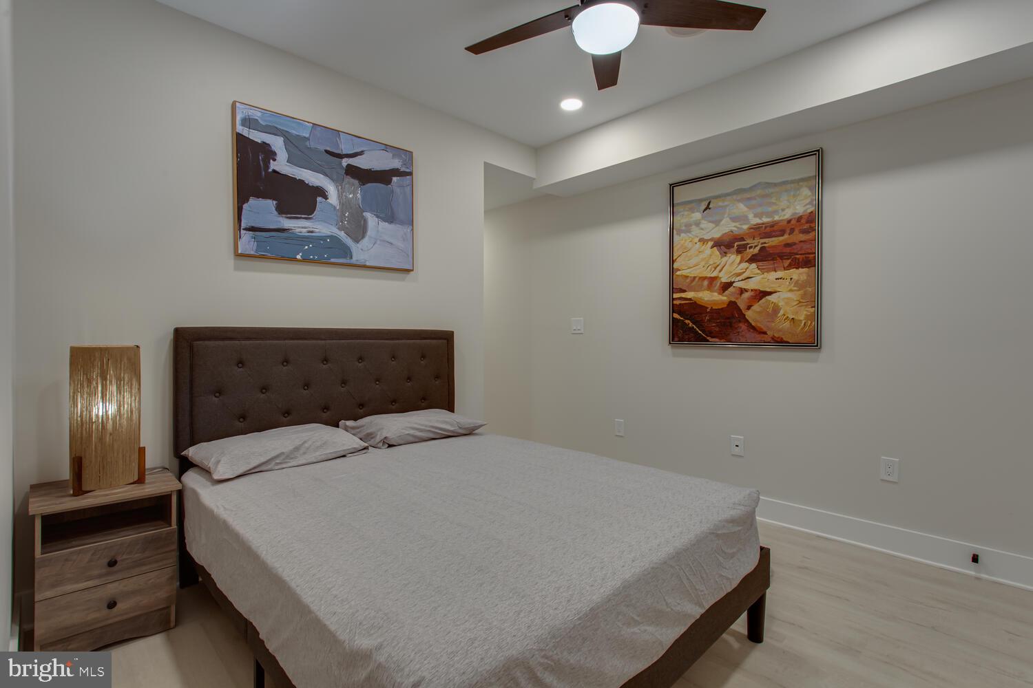 3554 13th Street Northwest, Unit 1 Washington, DC 20010 - Photo 18 of 25 a bedroom with a bed and a chandelier