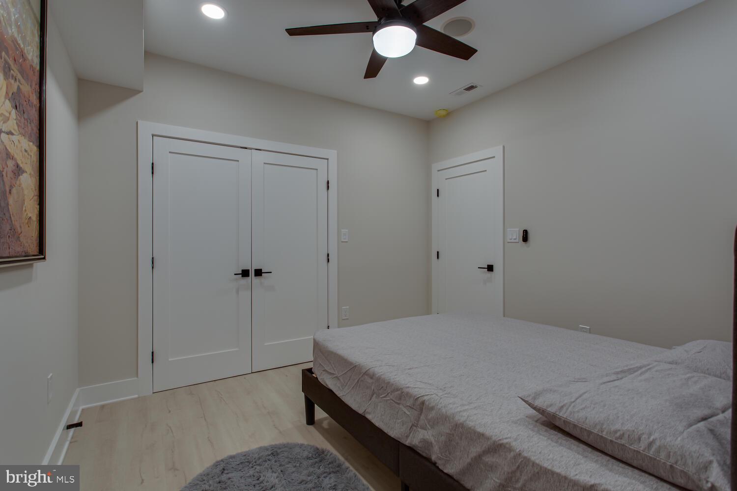 3554 13th Street Northwest, Unit 1 Washington, DC 20010 - Photo 20 of 25 a bedroom with a large bed and a chandelier