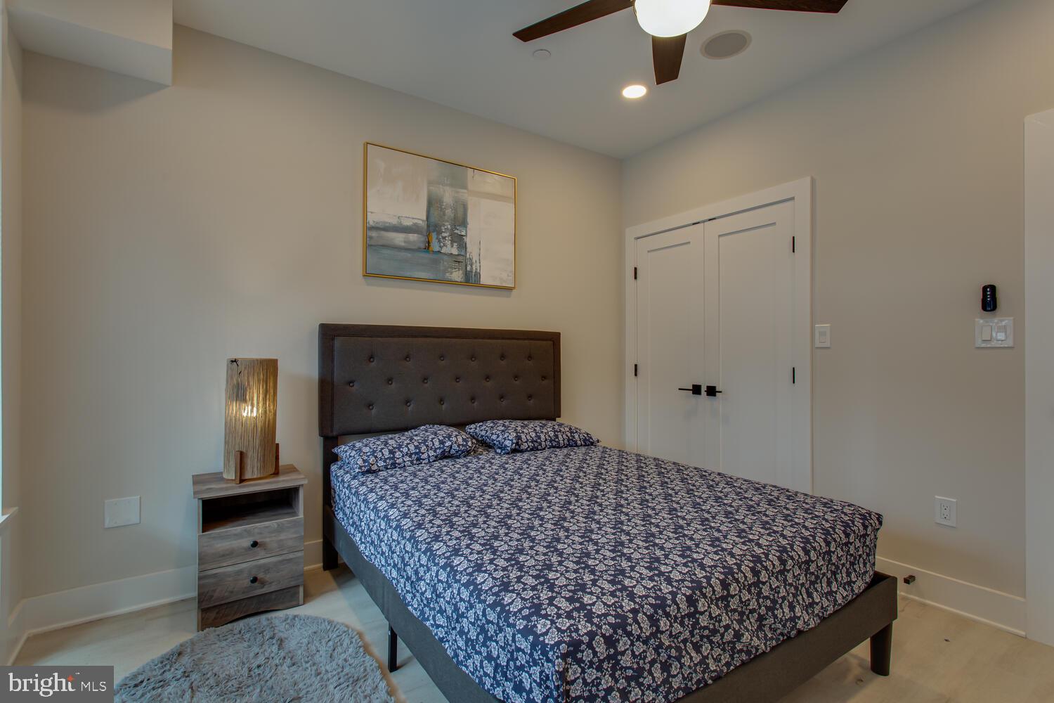 3554 13th Street Northwest, Unit 1 Washington, DC 20010 - Photo 22 of 25 a bedroom with a bed and a table with lamp