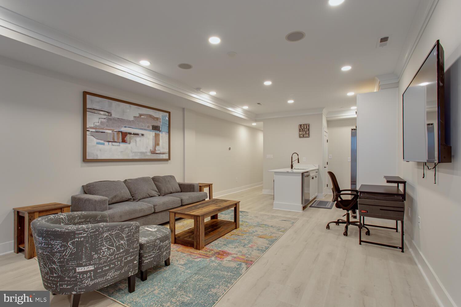 3554 13th Street Northwest, Unit 1 Washington, DC 20010 - Photo 5 of 25 a living room with furniture and a flat screen tv with kitchen view