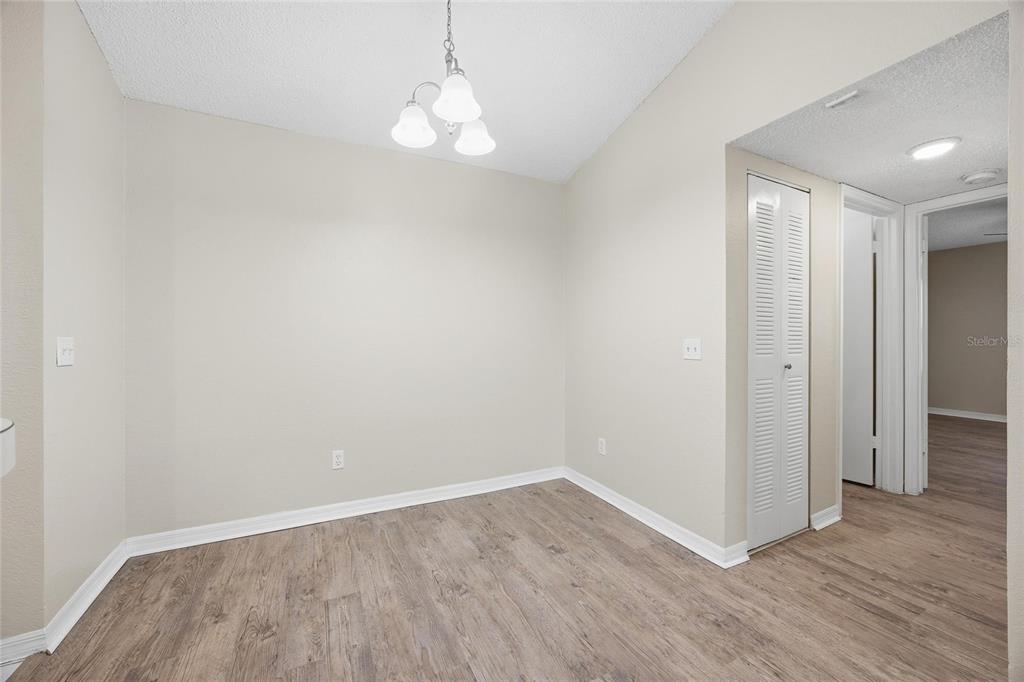 4532 Commander Drive, Unit 2132 Orlando, FL 32822 - Photo 12 of 26 a view of an empty room with wooden floor