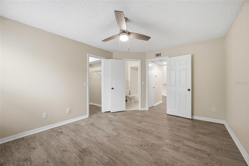 4532 Commander Drive, Unit 2132 Orlando, FL 32822 - Photo 15 of 26 an empty room with wooden floor and ceiling fan
