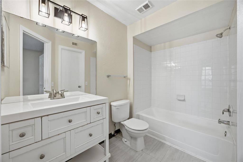 4532 Commander Drive, Unit 2132 Orlando, FL 32822 - Photo 16 of 26 a bathroom with a sink a toilet and shower