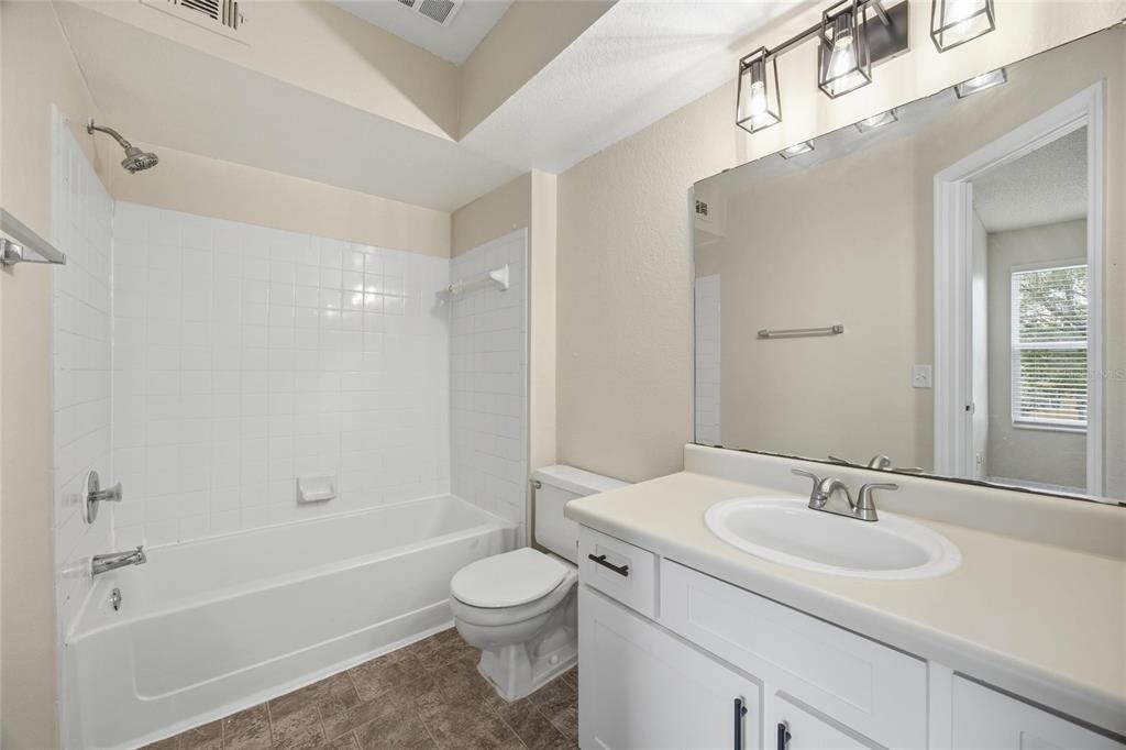 4532 Commander Drive, Unit 2132 Orlando, FL 32822 - Photo 19 of 26 a bathroom with a sink a toilet and shower