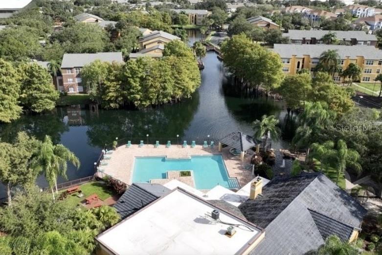 4532 Commander Drive, Unit 2132 Orlando, FL 32822 - Photo 20 of 26 an aerial view of a house with a yard and lake view